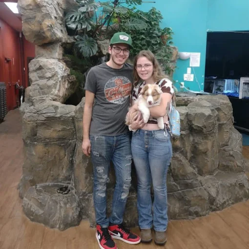 A couple holding a puppy at Petland